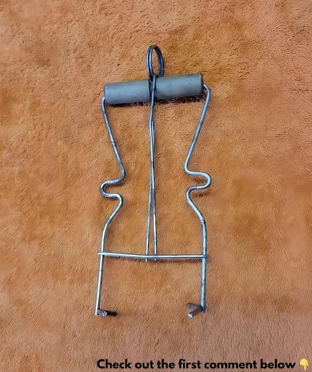 A classic vintage canning jar lifter, often used for safely removing hot jars from boiling water during the canning process